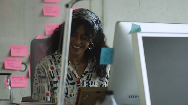 Woman getting notification on phone while working