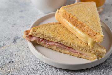 Ham and cheese sandwich sandwich cut in half on the plate at cafe.Popular packed lunch food