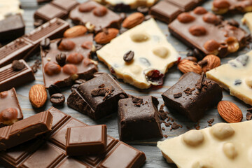 Different chocolate on gray wooden background, close up
