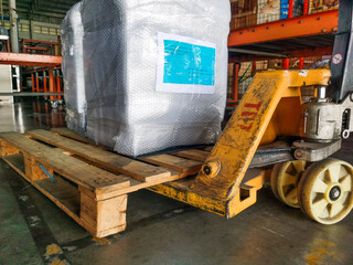 Wooden case shipment and goods package on hand lift pallet in cargo warehouse and ready loading to container truck for transportation to destination in logistics industry freight 
