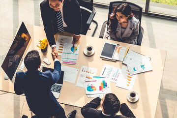Group business people handshake at meeting table in office together with confident shot from top...