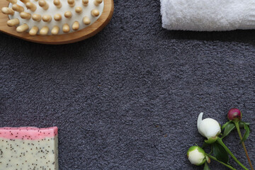 spa home. massage brush and soap on a background of gray towel