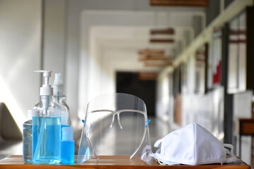 New normal, Hand sanitizer gel, faceshield and facemasks in front of the office for cleaning hands and wearing on face before getting inside to protect and prevent Coronavirus or Covid-19 and germs.