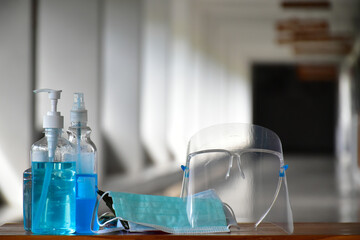 New normal, Hand sanitizer gel, faceshield and facemasks in front of the office for cleaning hands and wearing on face before getting inside to protect and prevent Coronavirus or Covid-19 and germs.