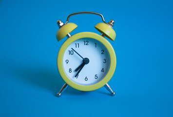 yellow alarm clock on a blue background