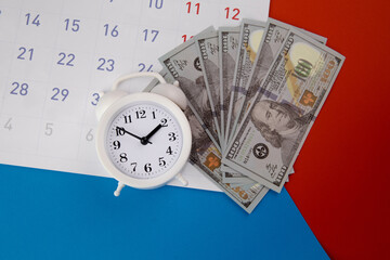 Tax payment season and finance debt collection deadline concept. Dollar banknotes, calendar and white clock.