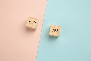 Choosing concept. Yes or No on wood blogs on colorful background