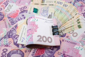 Ukrainian money. Bank loan. Business concept. Banknotes of 200 hryvnia compressed by a clip. Much money.