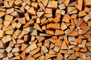 Stacks of Firewood. Firewood background. Background of dry chopped firewood. Wooden background. Preparation of firewood for the winter.