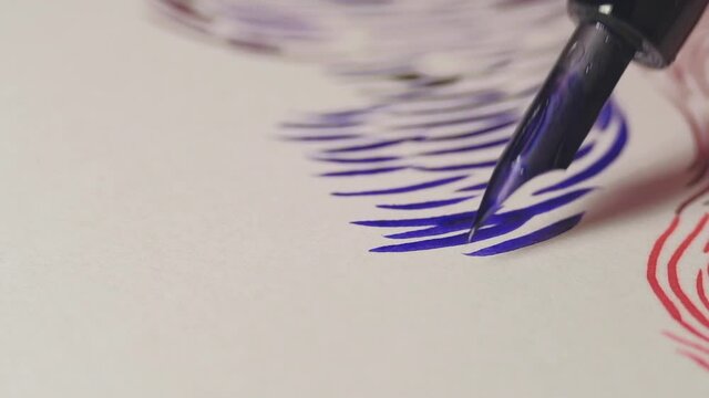 Close up of dip pen drawing wavy lines by blue ink. 4K resolution macro shot. High quality audio recorded with condenser microphone.