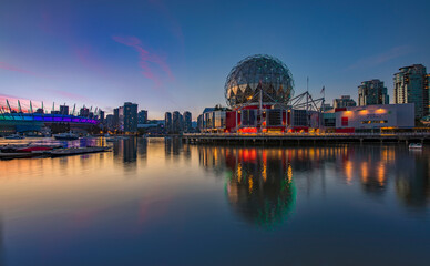 Iconic Science World at sunset blue hour with reflections in the water in Vancouver Canada