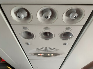 Passenger overhead panel in aircraft. Air condition, call light button, no smoking sign, seat belt sign, reading light. passenger loud speaker.