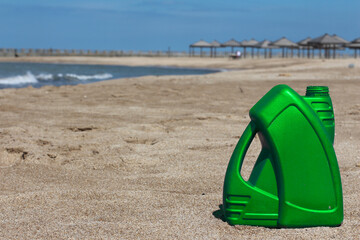 Colored plastic canister of motor oil on the beach. Green, Gold, Purple, Gray, Blue, Red, White.