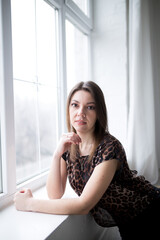 beautiful girl posing by the window.