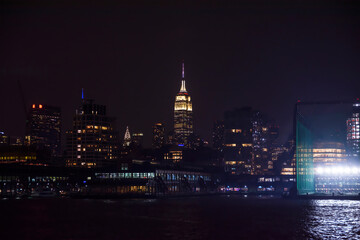 Fototapeta na wymiar Winter cruise . New York City skyline by night. View from Hudson river, New York, USA, America. 