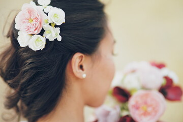Obraz na płótnie Canvas The girl's hair. Flowers in hair. Wedding bouquet.