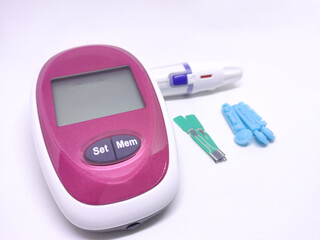 Diabetic set of lancet with spare needles, glucometer, strips, isolated on white background in...