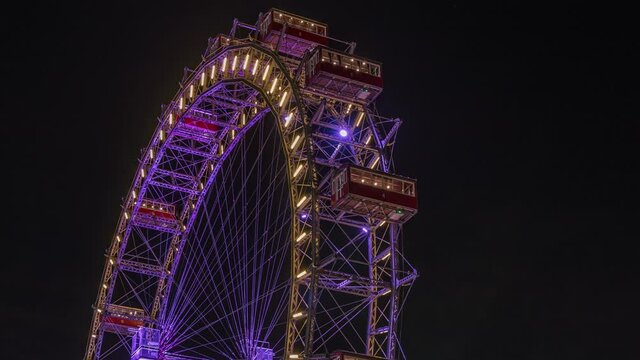 Wiener Riesenrad in Prater night timelapse - oldest and biggest ferris wheel in Austria. Symbol of Vienna city. View from park