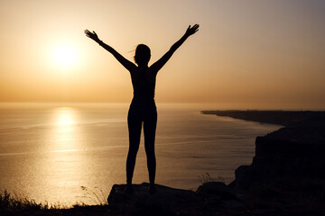 strong confidence woman open arms under the sunrise at seaside