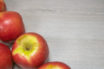Background on the theme of fruits, apples. Apples on a background of bleached wood.
