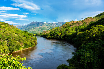 Panoramic view of mountains and highlands in the countryside of Colombia, South America. Beautiful picture of Magdalena river in the foreground