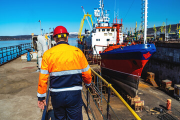 worker on the background of the ship