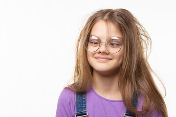 Girl with glasses trying to look at her nose.