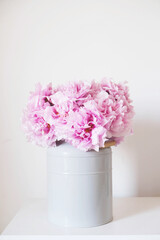 Beautiful bouquet of fresh pink peony flowers in full bloom in vase.