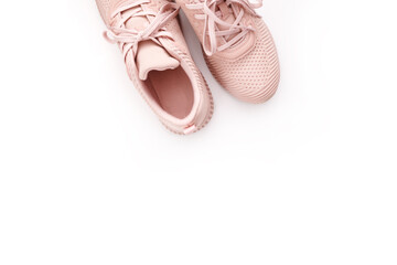 Pink female sneakers isolated on white background. Flat lay, top view