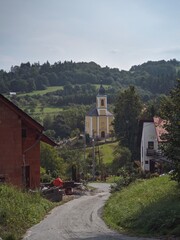 Fototapeta na wymiar view of a road to church in the hills during sunny summer day of czechia vacation