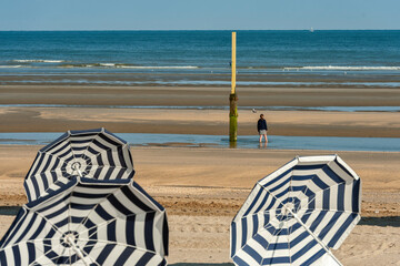 summer, sunbeds, striped parasols at De Panne beach, Belgium
