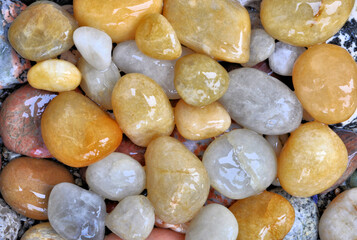 Closeup of wet and colorful beach stones of different sizes and shapes. Possible background image.