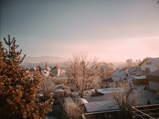 romantic overwhelming colorful sunrise in the frosty winter cold weather trees with snow view from the balcony