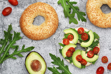 Sesame bagels with tomatoes and avocado