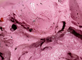 Tasty fresh blueberry ice cream, pink and purple color and creamy texture as background.