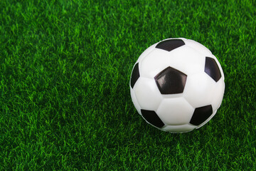 Fototapeta premium Traditional soccer ball on soccer field. Football ball on green grass stadium football field, game, sport. Background for design.