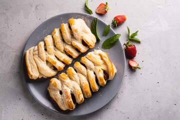 Chocolate puff pastry. Home baked dark chocolate sweet pie on grey background with copy space