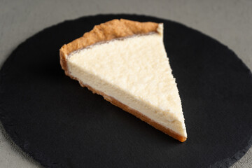 Vegetarian cheesecake on a black slate Board
