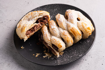 Chocolate puff pastry. Home baked dark chocolate sweet pie on grey background with copy space