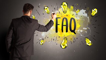 businessman drawing colorful light bulb with FAQ abbreviation, new technology idea concept