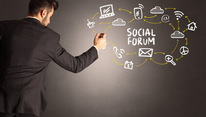 businessman drawing social media icons with SOCIAL FORUM inscription, new media concept