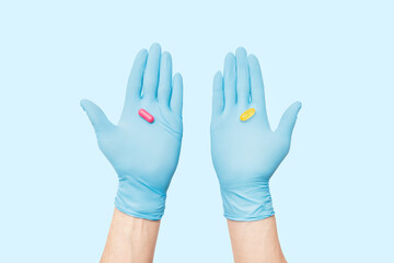 The doctor's holding two alternative medicines for the treatment of the disease in the palm of his hand. The patient needs to choose his own option