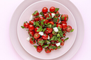 Homemade cherry tomato salad with fresh onions, mint, olive oil and salt