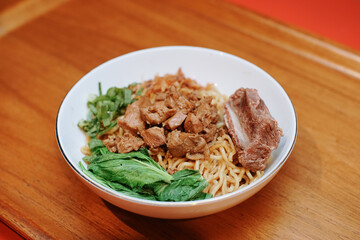 Chicken noodles with beef rib. pieces of mustard leaf