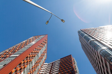 Low angle shot of modern infinity corporate city buildings with clear blue sunny sky background.