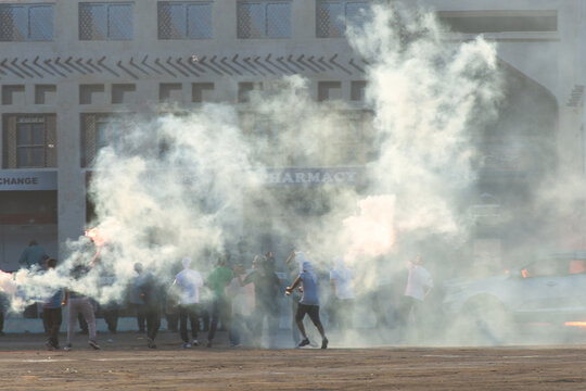 Military Police Riot Response To A Protest With Tear Gas, Smoke, Fire, Explosions. Political Expression, Riot, Protest, Demostration And Military Concept.