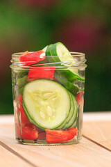 cucumber with herbs in a jar