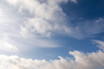 Mix of hard and soft white clouds in blue sky