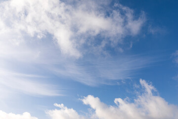 Mix of hard and soft white clouds in blue sky