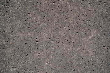 Grey concrete wall background texture. Rough surface with scuffs and dots